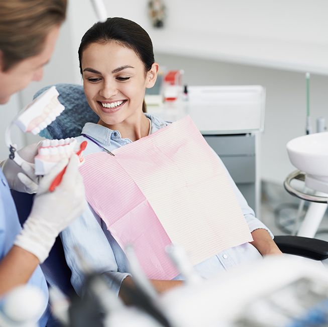 Happy patient talking to dentist